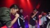 An audience member, second from right, raps with members of Rap Against Dictatorship on stage in Bangkok, Oct. 27, 2018. The group has touched a nerve with an impassioned and now-viral music video lobbing fiery rhymes at the ruling junta.