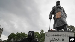 FILE - Protesters gather around the Winston Churchill statue in Parliament Square during a Black Lives Matter rally in London June 7, 2020.
