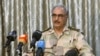 FILE - General Khalifa Haftar speaks during a news conference at a sports club in Abyar, a small town to the east of Benghazi.