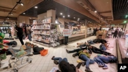 Warga Ukraina berbaring di lantai toserba, berpura-pura mati dalam protes menentang produk Rusia di Kyiv, Ukraina, 5 April 2014. 