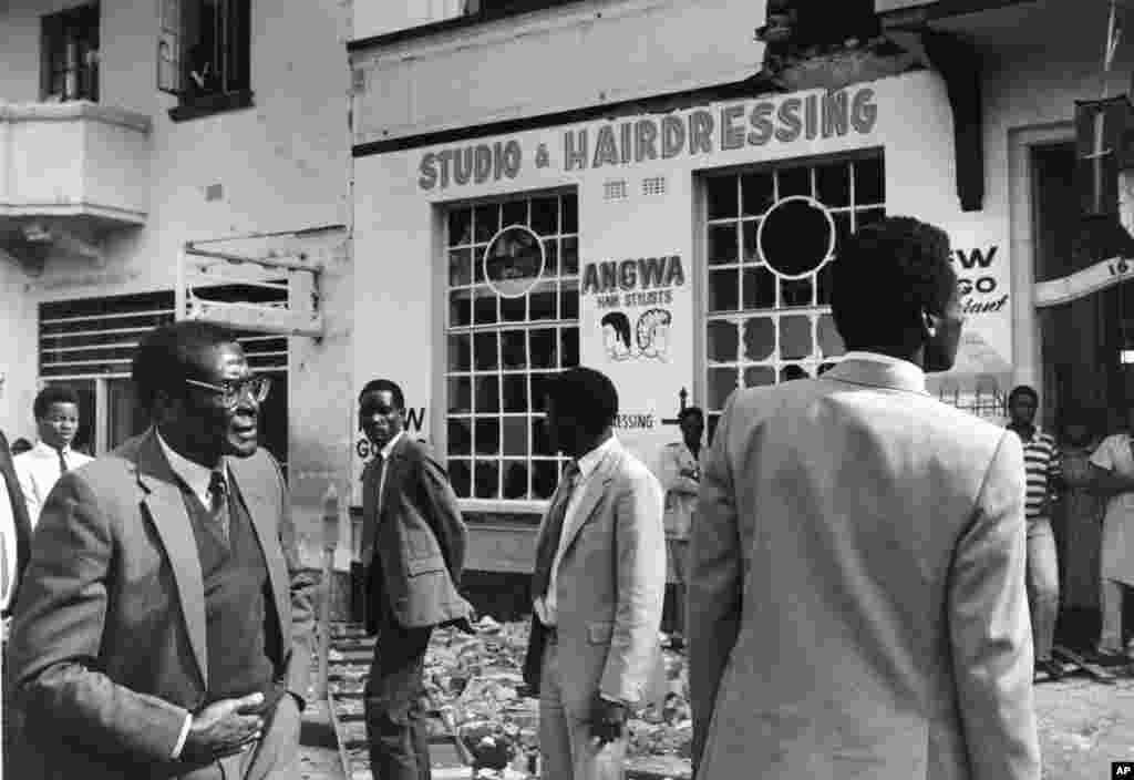 Zimbabwe Prime Minister Robert Mugabe stands in the rubble outside the building which housed the headquarters of the African National Council in central Harare, after it was heavily damaged in a raid by South African commandos, May 19, 1986.