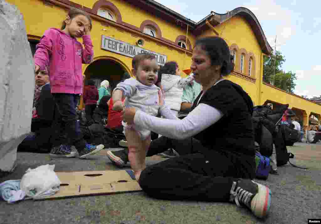 A group of immigrants who passed through police blockades arrive at the Gevgelija railway station, Aug. 21, 2015.