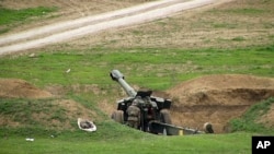 Armenian soldiers aim a howitzer, April 3, 2016, in the village of Mardakert, in the separatist region of Nagorno-Karabakh.