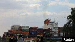 A ship is seen after sailing through Suez Canal as traffic resumes after a container ship that blocked the waterway was refloated, in Ismailia, Egypt, March 30, 2021. 