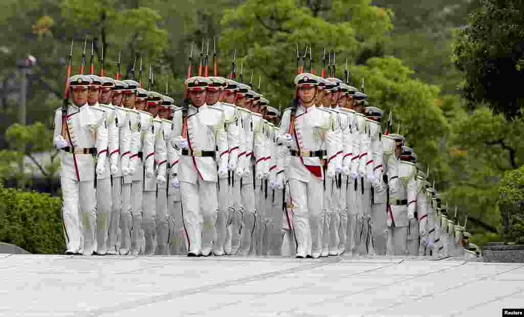 Members of Japan's Self-Defense Force's honor guard march before a ceremony for Prime Minister Shinzo Abe at the Defense Ministry in Tokyo.