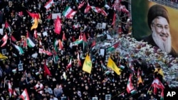 Mourners attend a rally commemorating slain Hezbollah leader Hassan Nasrallah, shown in billboard, at Felestin (Palestine) Square in downtown Tehran, Iran, Sept. 30, 2024. 