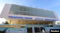 People arrive at the newly rebuilt National Theater, to watch the first film festival held in the capital of Mogadishu, Somalia, Sept. 22, 2021