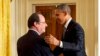 French President Francois Hollande shakes hands with President Barack Obama after their joint news conference in the East Room of the White House, Feb. 11, 2014.