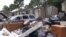 When the rains stopped in the Houston area for several hours Tuesday, residents pulled water-damaged carpets, furniture and other belongings out of their apartment buildings, leaving piles of debris outside their doors. (G. Flakus/VOA)