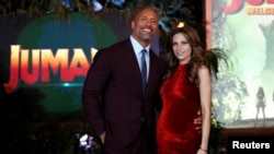 FILE - Cast member Dwayne Johnson and Lauren Hashian pose at the premiere for "Jumanji: Welcome to the Jungle" in Los Angeles, California, Dec. 11, 2017. 