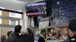 People watch the trial of former Algerian Prime Ministers Ahmed Ouyahia and Abdelmalek Sellal, in a cafe of Algiers, Dec. 4, 2019.