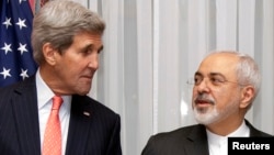 FILE - U.S. Secretary of State John Kerry (l) and Iran's Foreign Minister Mohammad Javad Zarif pose for a photograph before resuming talks over Iran's nuclear program in Lausanne, March 16, 2015. 