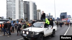 Construction workers and far right activists protest against coronavirus disease (COVID-19) restrictions on the West Gate Freeway in Melbourne, Australia, Sept. 21, 2021.