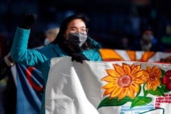 FILE - Tenants' rights advocates march from the Edward W. Brooke Courthouse, Jan. 13, 2021, in Boston. The protest called on the incoming Biden administration to extend the eviction moratorium initiated in response to the COVID-19 pandemic.