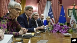 Energy Ernest Moniz, third left, National Security Council point person on the Middle East Robert Malley, 2nd right, and European Union Political Director Helga Schmid attend a meeting with Iranian officials at a hotel in Lausanne, Switzerland, March 26
