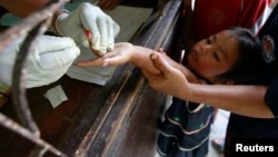 Children living along the Thai-Burma border come to a malaria clinic in Sai Yoke district, Kanchanaburi Province, to get tested, October 26,2012. 