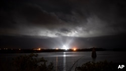 A SpaceX Falcon 9 rocket with the company's Crew Dragon spacecraft onboard is seen illuminated by spotlights on the launch pad at Launch Complex 39A, Saturday, Nov. 14, 2020, at NASA's Kennedy Space Center, at Cape Canaveral, Fla.