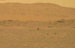 In this image from NASA, NASA's experimental Mars helicopter Ingenuity lands on the surface of Mars, April 19, 2021.