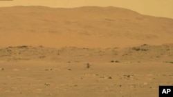 FILE - In this image from NASA, NASA's experimental Mars helicopter Ingenuity lands on the surface of Mars, Apr. 19, 2021. 