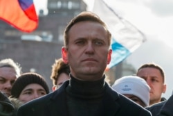 FILE - Russian opposition politician Alexei Navalny takes part in a rally to mark the 5th anniversary of opposition politician Boris Nemtsov's murder and to protest against proposed amendments to the country's constitution, in Moscow, Feb. 29, 2020.