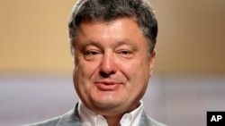 Ukrainian presidential candidate Petro Poroshenko talks, during a press conference, in Kiev, Ukraine, Monday, May 26, 2014