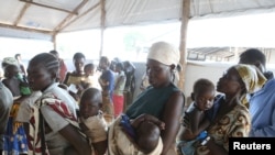 FILE - Women who fled fighting in South Sudan wait with their children for the immunization of their children on arrival at Bidi Bidi refugee’s resettlement camp near the border with South Sudan, in northern Uganda, Dec. 7, 2016.