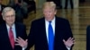 President Donald Trump accompanied by Senate Majority Leader Mitch McConnell of Ky., left, arrives for a Senate Republican policy lunch on Capitol Hill in Washington, March 26, 2019.