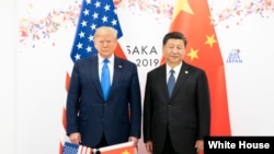 资料照：2019年6月29日，美国总统特朗普在日本大阪举行的二十国集团峰会上与中华人民共和国主席习近平举行双边会晤。