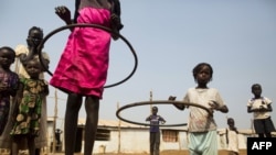 FILE - Children play with hula hoops at a UNICEF site in Juba, South Sudan, on Jan. 15, 2016. A new program to bring teenage mothers back to school is helping the country address the gender gap in education, experts say.