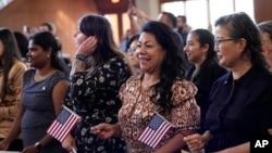 FILE - Women take part in a naturalization ceremony, March 8, 2024, in San Antonio. More than half the U.S. foreign-born population lives in just four states — California, Texas, Florida and New York — a Census Bureau report released in April 2024 said.