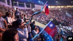 Evangelical Christians wave Taiwanese flags and another blows a shofar during a gathering in Jerusalem. Thousands of evangelical Christians from more than 80 countries descended upon Jerusalem this week to profess their love for the Jewish state, Sept. 29