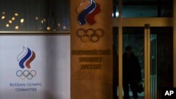 FILE - A member of security guards a Russian Olympic committee building in Moscow, Russia, Monday, Nov. 9, 2015. 