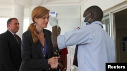 Dubes AS untuk PBB, Samantha Power, membersihkan tangannya dan diambil suhu tubuhnya di markas PBB untuk misi respon Ebola di Conakry, Guinea (26/10).