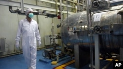 FILE - In this Feb. 2007 photo, an Iranian technician walks through the Uranium Conversion Facility just outside the city of Isfahan 410 kilometers (255 miles) south of the capital, Tehran.