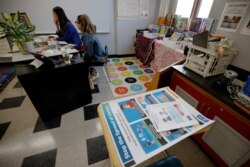 FILE - Teachers Mary Yi and Ibis Blanco work with their students virtually from their classroom at Sokolowski Elementary School in Chelsea, Mass., Sept. 16, 2020.
