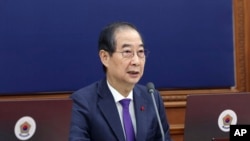 South Korea's Prime Minister Han Duck-soo, who became the country's acting leader after President Yoon Suk Yeol's impeachment, speaks during a Cabinet meeting at the government complex in Seoul, Dec. 17, 2024. (Hong Hae-in/Yonhap via AP)