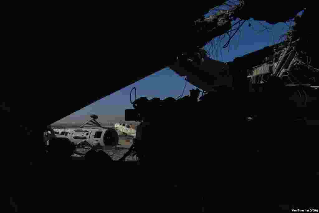 Airplanes and air defense systems were destroyed by Israeli air strikes that hit the Mazzeh air base multiple times in the last week, in Damascus, on Dec. 19, 2024. (Yan Boechat/VOA)