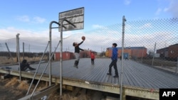 Yupik Eskimo children play basketball on a court built above the permafrost in the town of Napakiak on the Yukon Delta, Alaska on April 18, 2019.