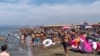 People enjoy the beach in Fregene, a fashionable sea resort some 30km (19 miles) north of Rome, July 26, 2020. 