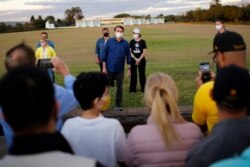 Brazil's President Jair Bolsonaro greets supporters during a ceremony of lowering the national flag for the night, amid the coronavirus disease (COVID-19) outbreak, at the Alvorada Palace in Brasilia, July 18, 2020.