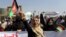 Afghan women shout slogans and wave Afghan national flags during an anti-Pakistan demonstration, near the Pakistan embassy in Kabul, Afghanistan, Sept. 7, 2021. Sign in Persian at right reads, "Pakistan Pakistan Get out from Afghanistan."