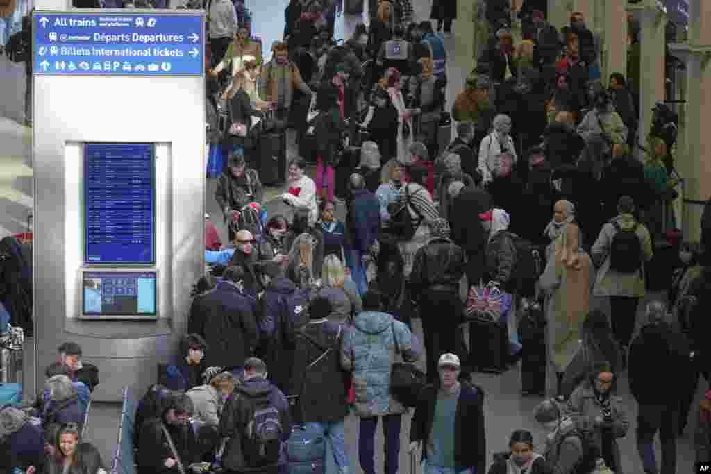 Passengers wait near departures for Eurostar services at St. Pancras International station in London, after Eurostar trains to the capital were halted following the discovery of an unexploded Second World War bomb near the tracks in Paris.