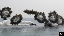 South Korean marine's amphibious assault vehicles sail to shores in a smoke screen for landing during the U.S.-South Korea joint landing military exercises as a part of the annual joint military exercise Foal Eagle between South Korea and the United State