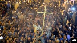 Coptic Christians react after a funeral service for some of the victims of a bus attack, at Abu Garnous Cathedral in Minya, Egypt, May 26, 2017. 