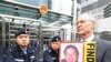 Solicitor John Clancey (R), a member of a lawyers concern group protests for the release of Beijing human rights lawyer Gao Zhisheng outside the China Liaison office in Hong Kong, 04 Feb 2010