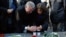 FILE - New York City Mayor Bill de Blasio and Paris Mayor Anne Hidalgo light candles in tribute to the victims of the terror attack against Charlie Hebdo at Place de la Republique in Paris, Jan. 20, 2015.