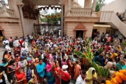 Devotees wait to offer prayer at Lord Jagannath temple ahead of annual Rath Yatra or chariot procession in Ahmedabad, India, July 10, 2021.