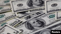 FILE - US $100 bills are seen in this picture illustration taken in Seoul, Feb. 7, 2011.