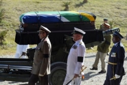 FILE - The coffin of South African former president Nelson Mandela is carried on a gun carriage for a traditional burial in Qunu, South Africa, Dec. 15, 2013.