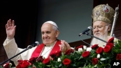 Pope Francis, left, and Ecumenical Patriarch Bartholomew I bless the faithful gathered in the courtyard of the Patriarchal Church of St. George in Istanbul, Turkey, Nov. 30, 2014. 